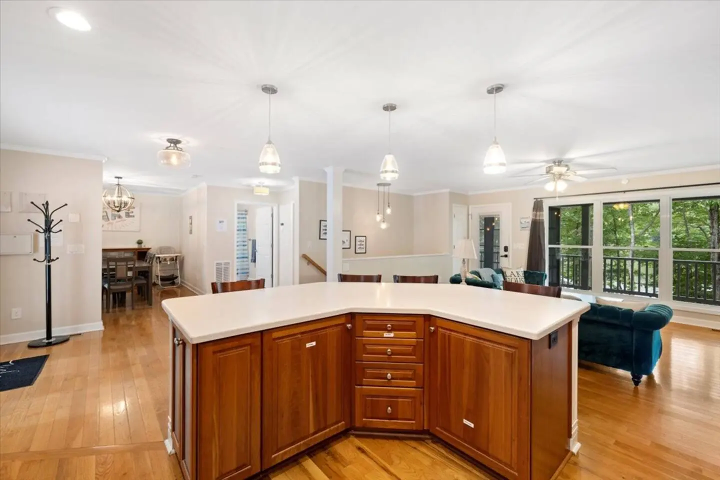 Warm wood-cabinet kitchen with stainless appliances and a center island