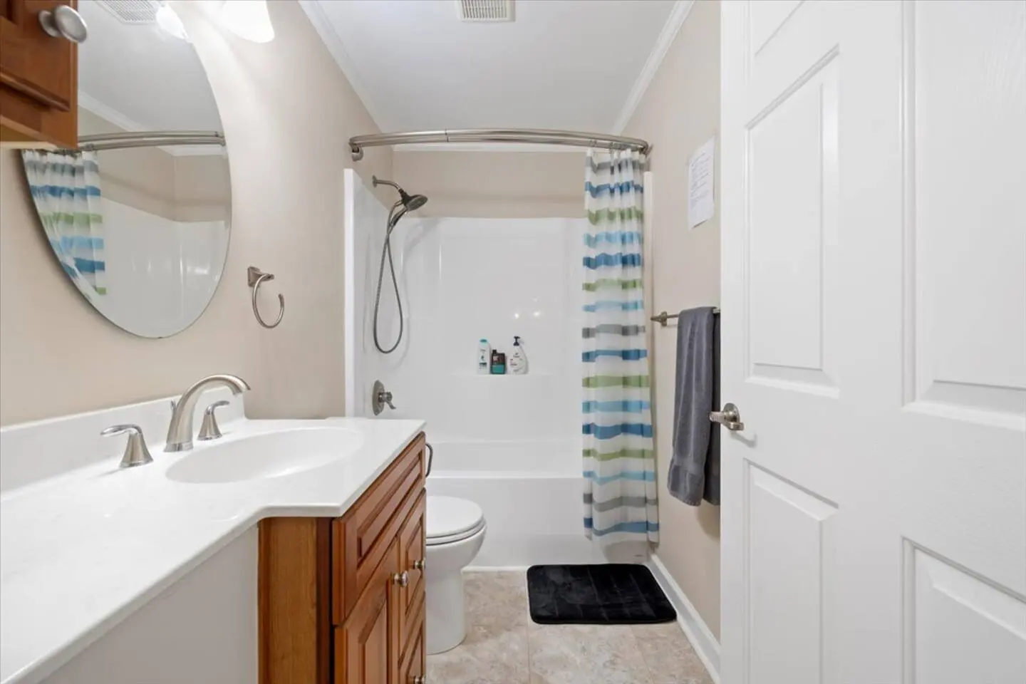 Renovated bathroom with a glass walk-in shower and a clean white vanity