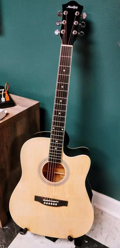 Acoustic guitar hanging on the game-room wall